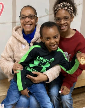 A smiling Wild Roots family sharing a happy moment together